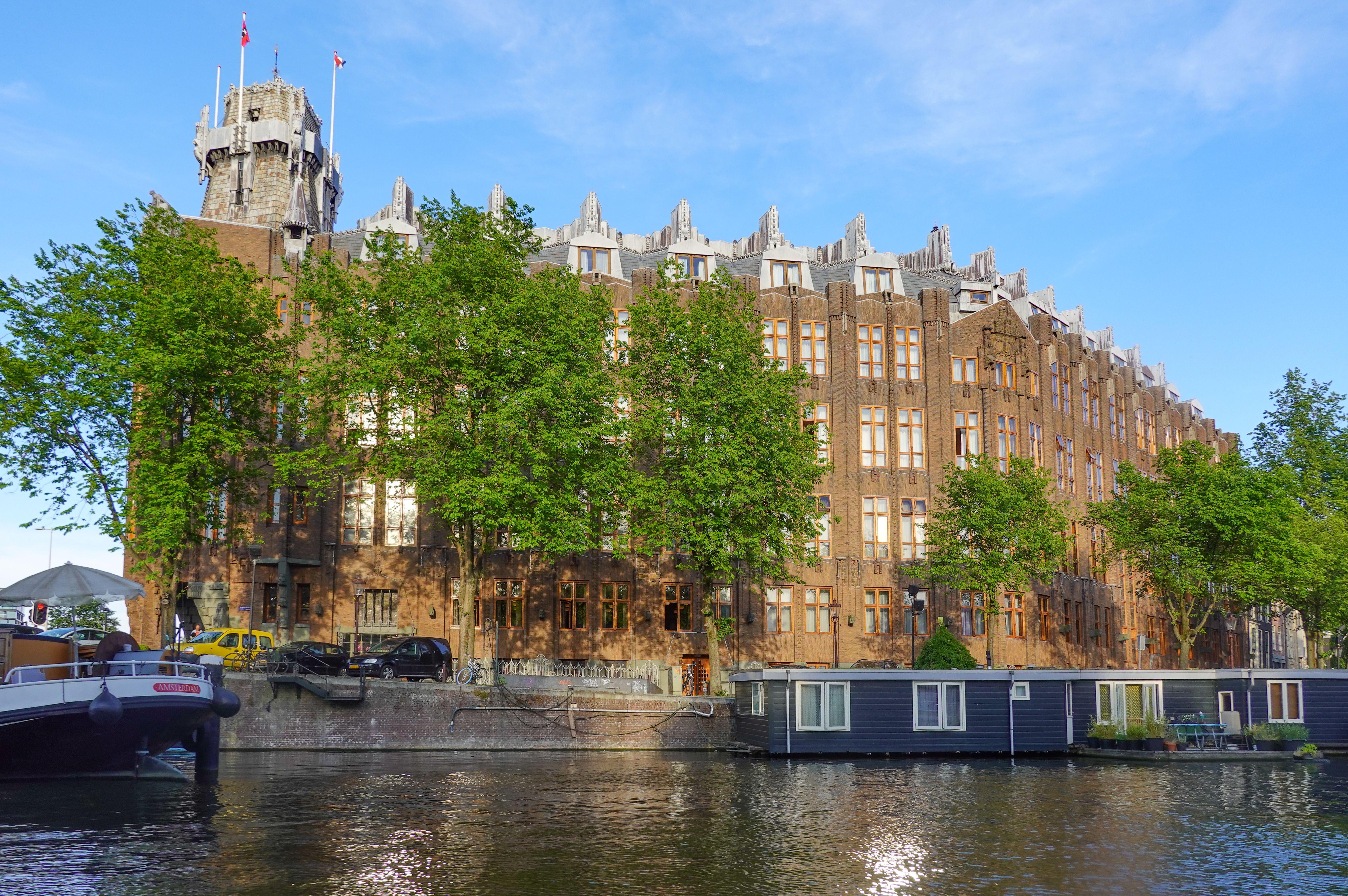Brick front with carved stone and ironwork on a canal quay