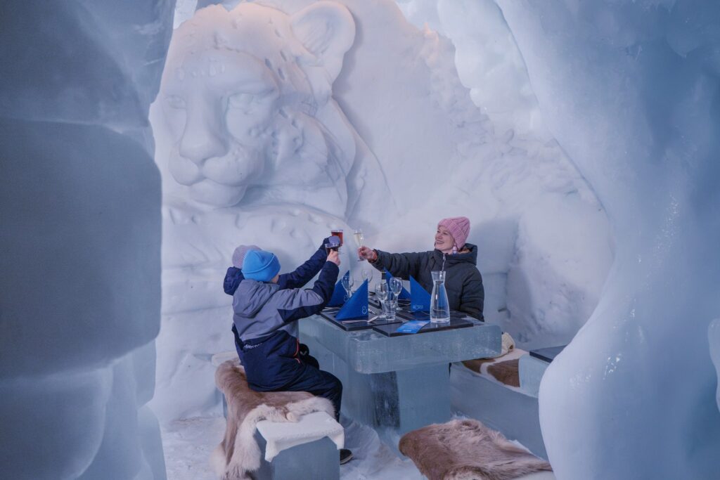Snow-walled sleeping chamber with a bed set on ice blocks
